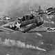 SBD-3 Dauntless dive bombers of scouting squadron VS-8 from the aircraft carrier USS Hornet (CV-8) approach the burning Japanese heavy cruiser Mikuma during the Battle of Midway on June 6, 1942 (US Navy)